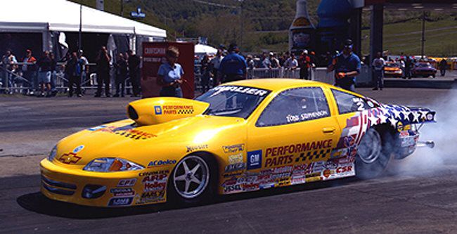Yellow funny car launching off the line