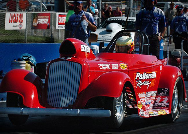 Red roadster drag car staging in the pits