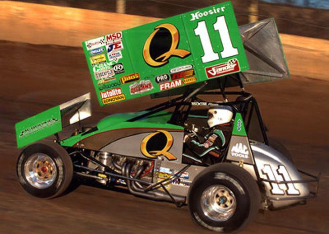 Number 11 sprint car running on a dirt track