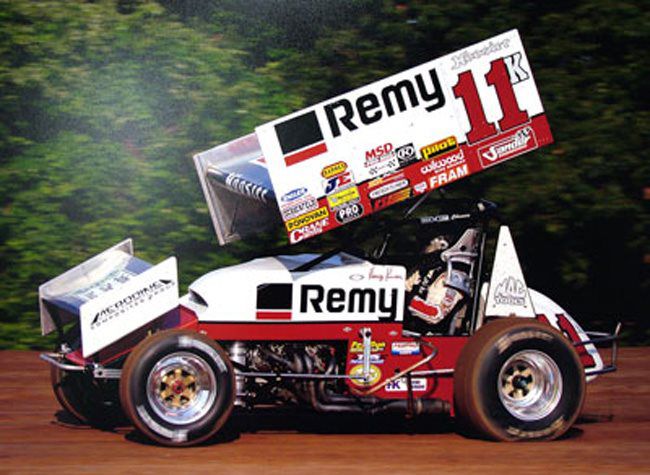Number 11 Remy liveried sprint car on a dirt track